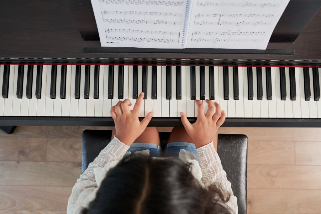 Girl playing on musical instrument