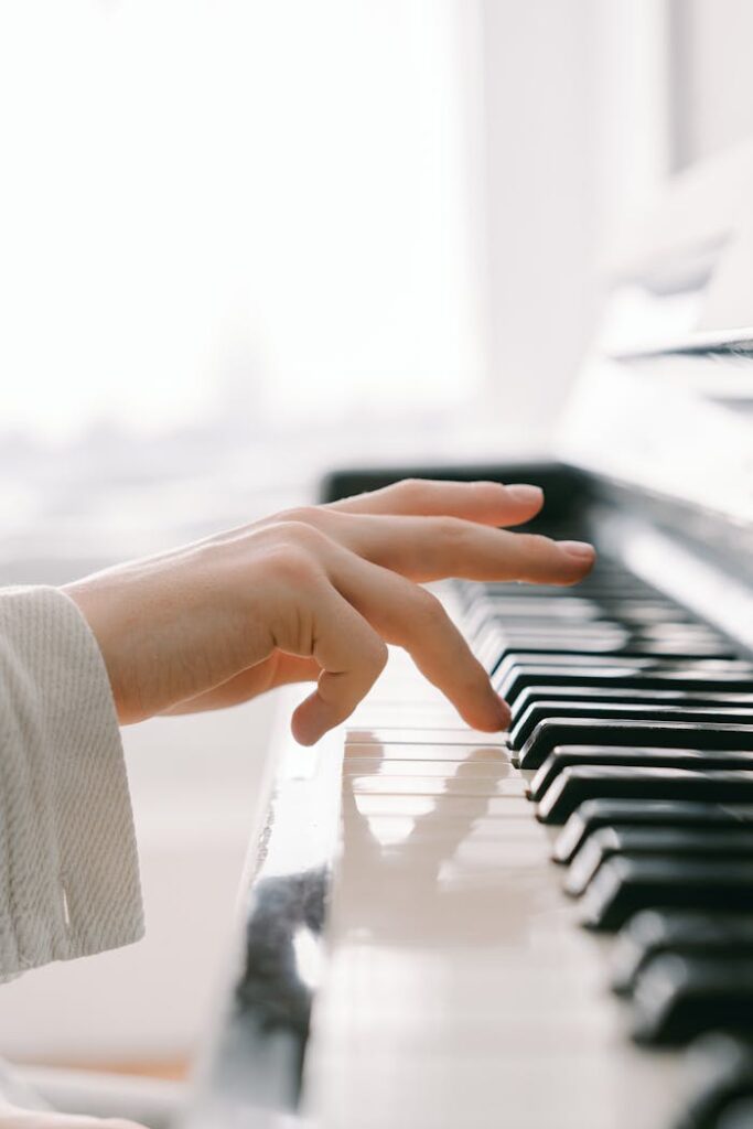 pexels-photo-7570763 A close-up shot of a hand gracefully playing piano keys, emphasizing musical expression.